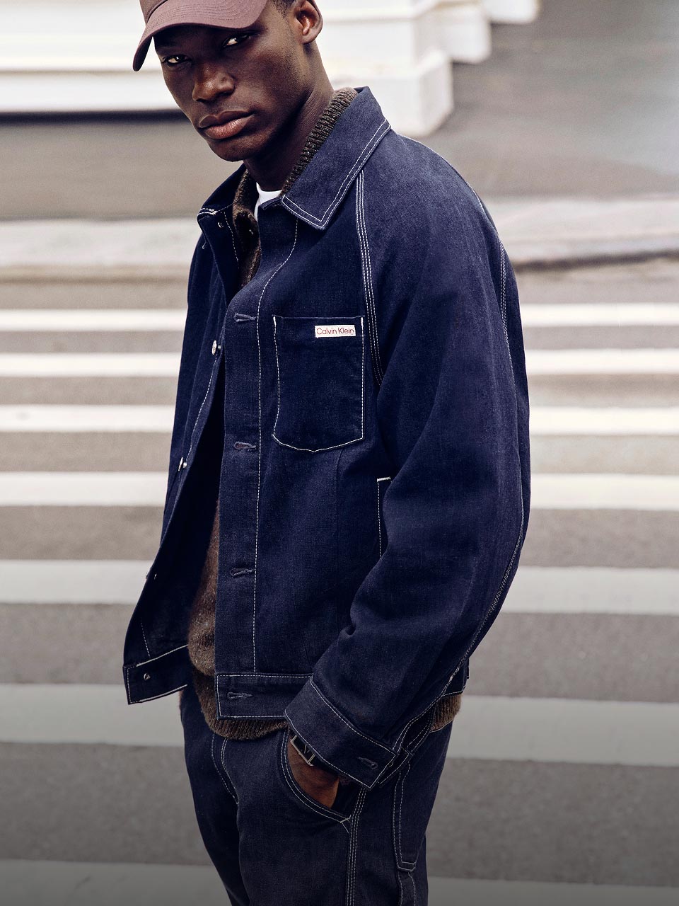 Model posing in a denim jacket and jeans