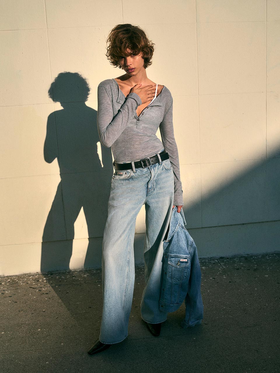 Model posing in light blue baggy jeans
