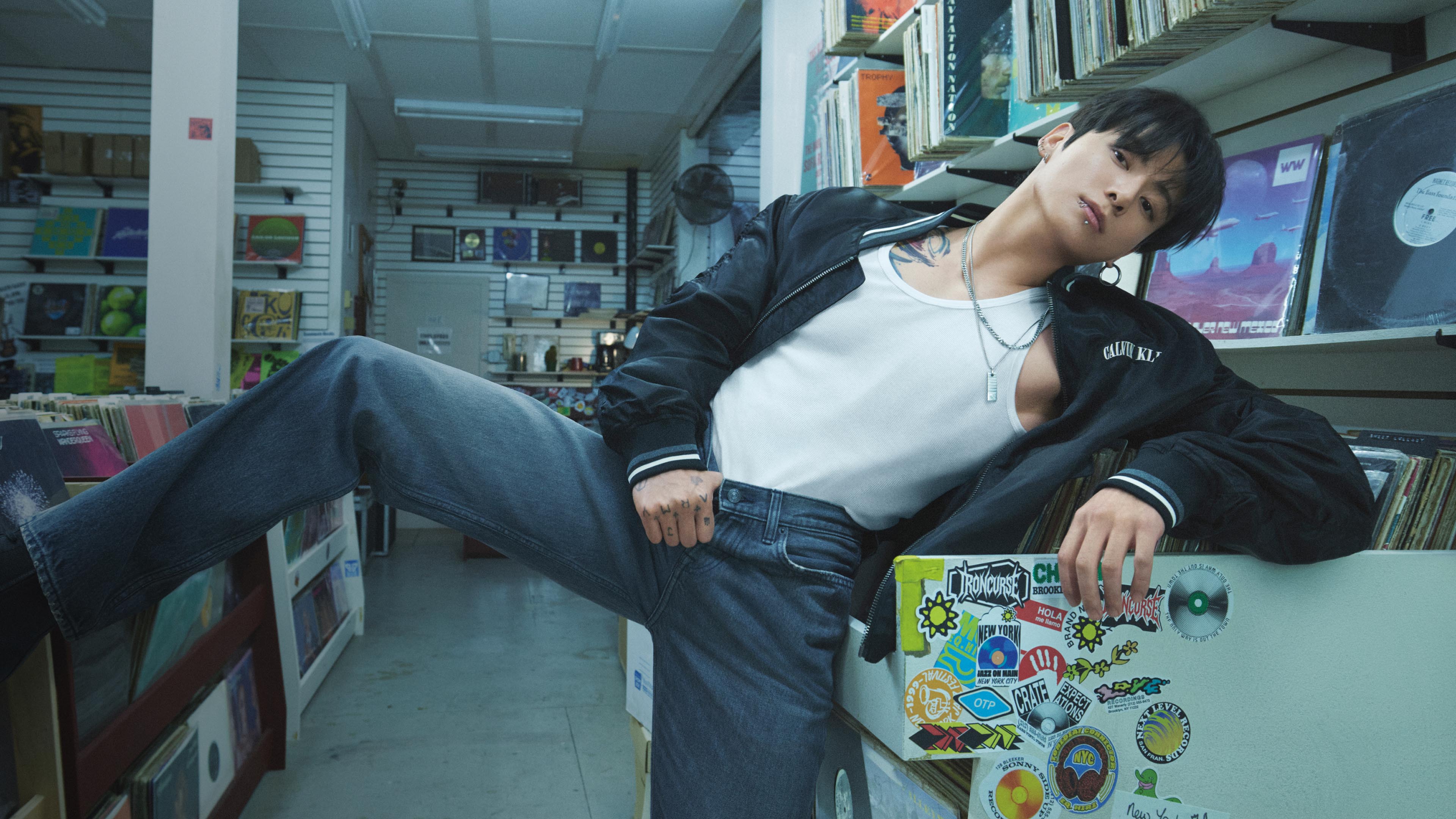 Jung Kook posing in a bomber jacket