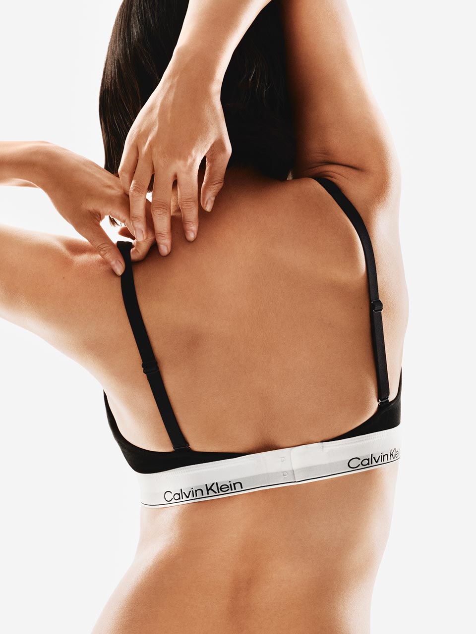 Model posing in a Calvin Klein bralette