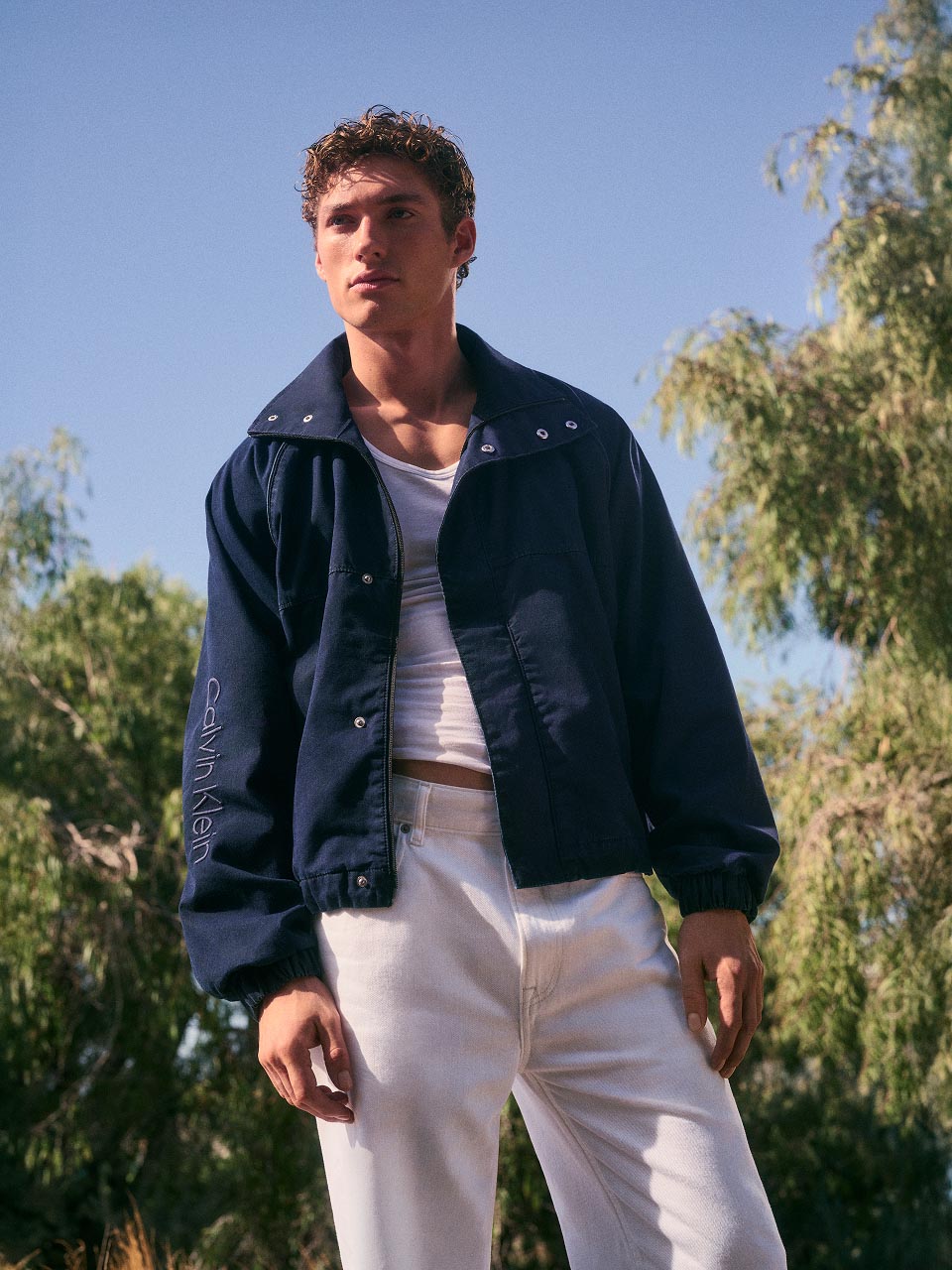 Model posing in a denim jacket and jeans