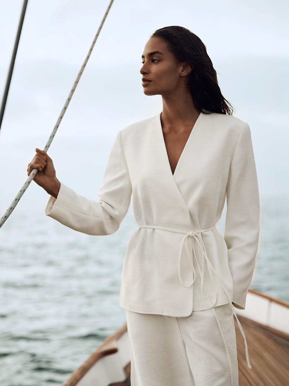 Model posing in a white blazer