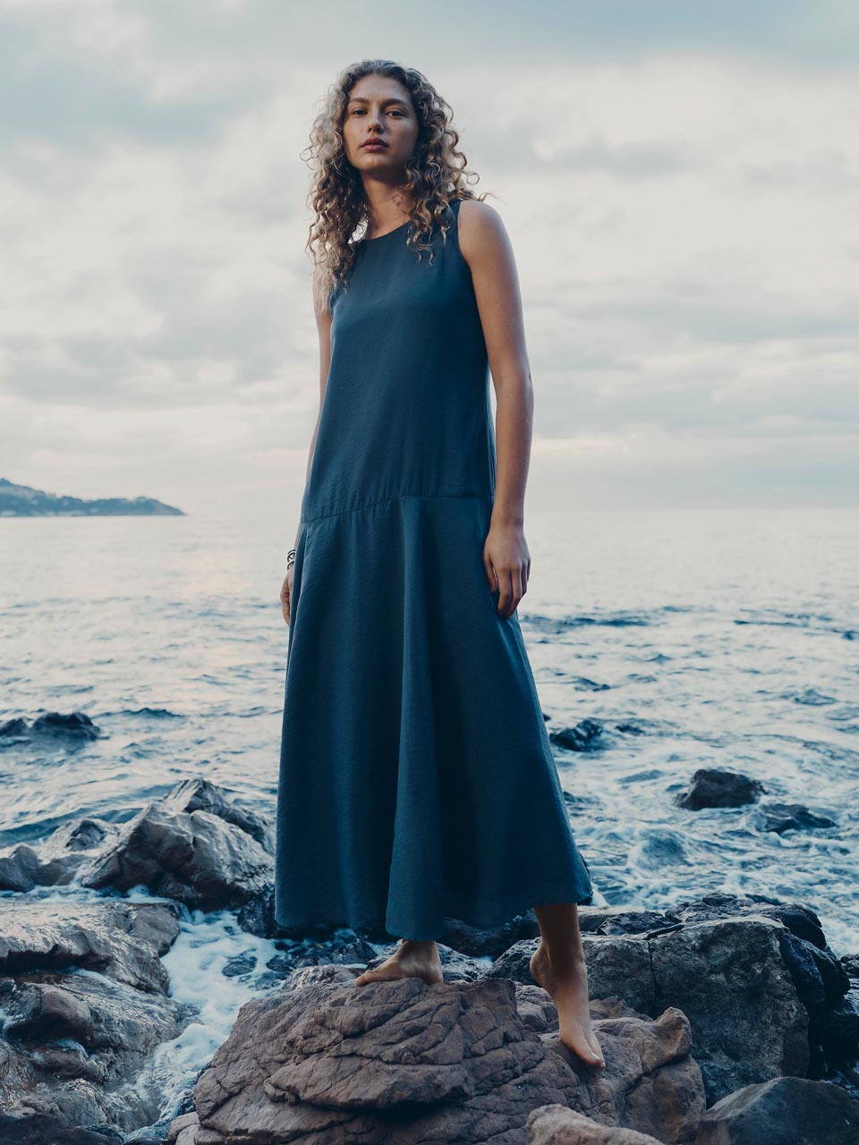 Model posing in a blue dress