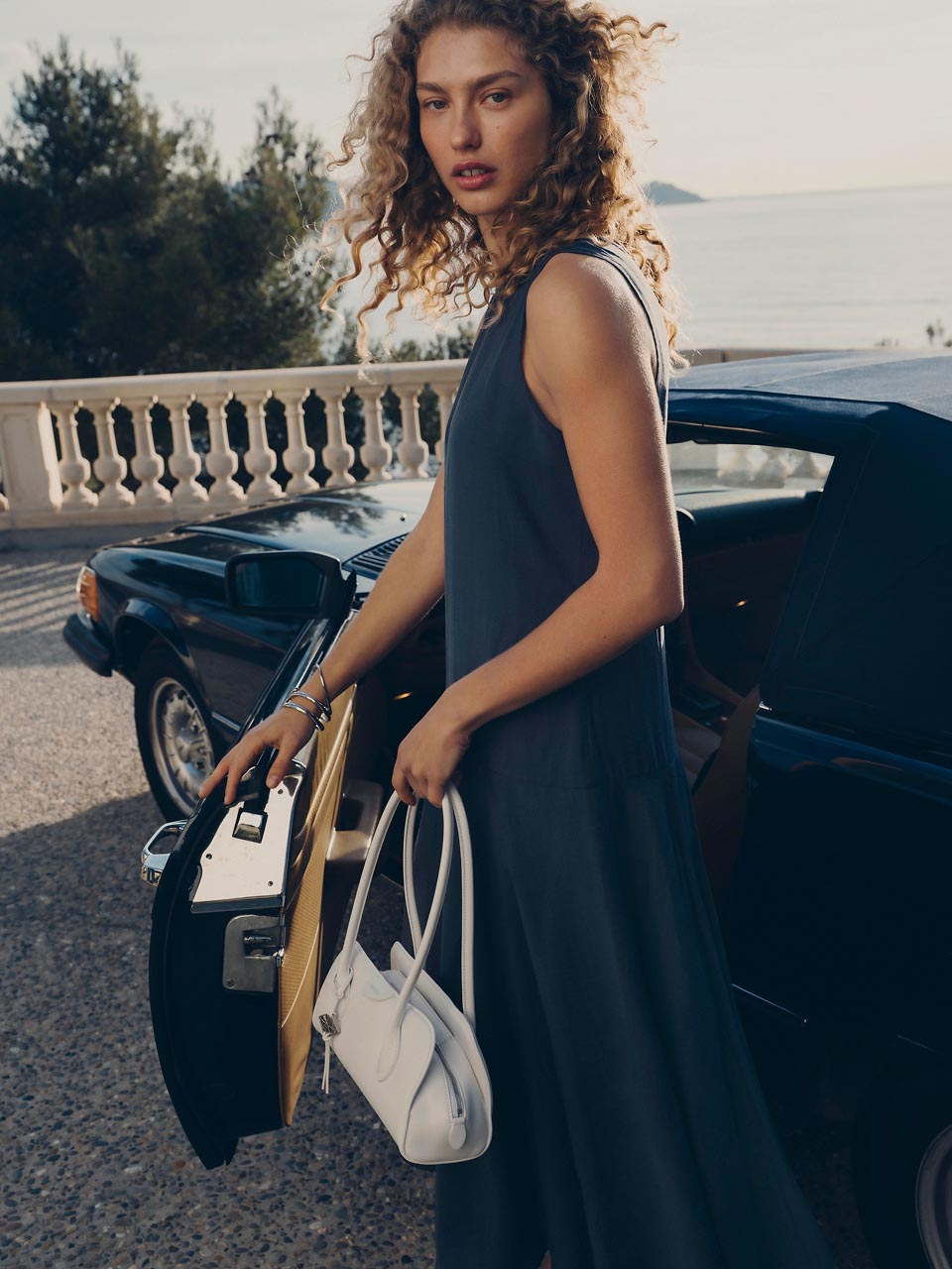 Model posing in a blue dress