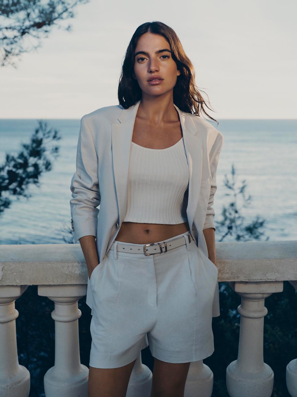 Model posing in white shorts