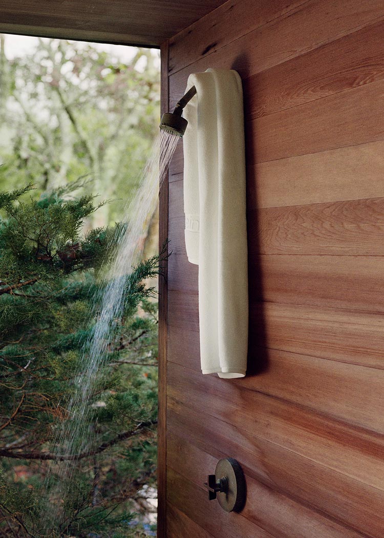 Still life image of a white towel hanging in a shower