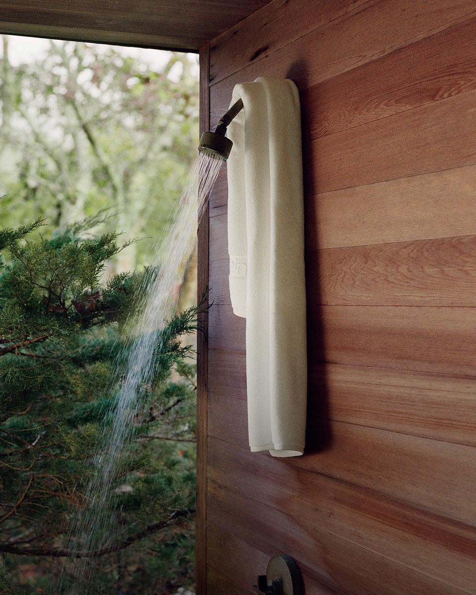 Still life image of a white towel hanging in a shower