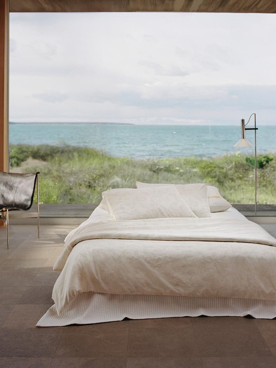 Still life image of a bed with white bedding