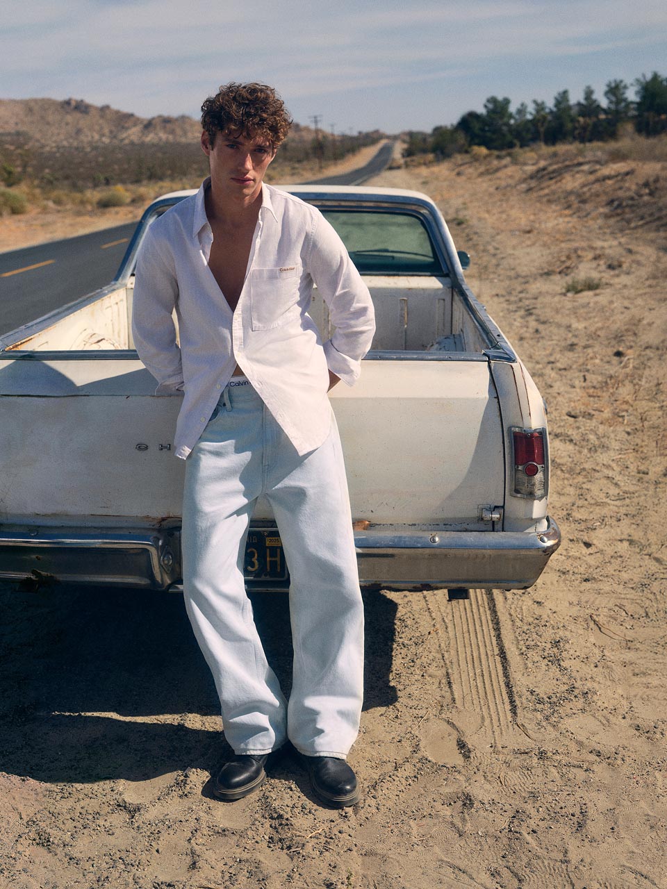 Model posing in light denim