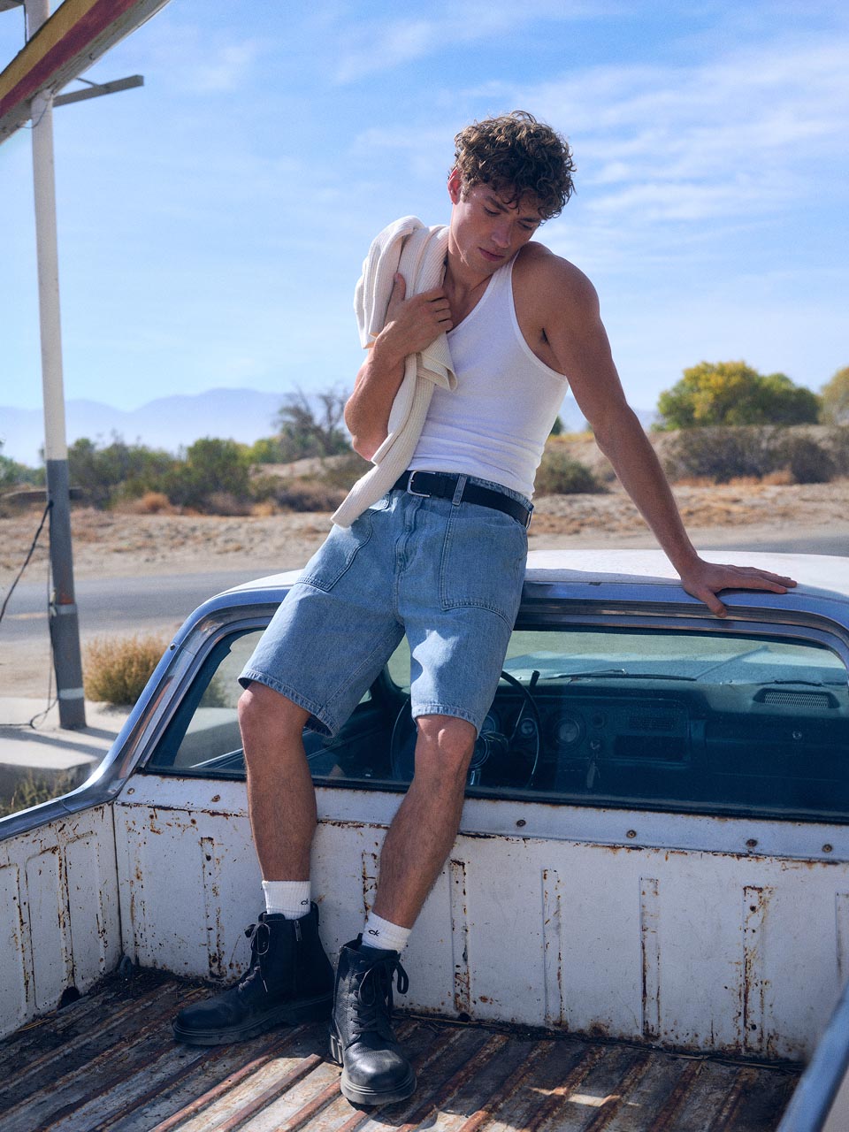 Model posing in denim shorts