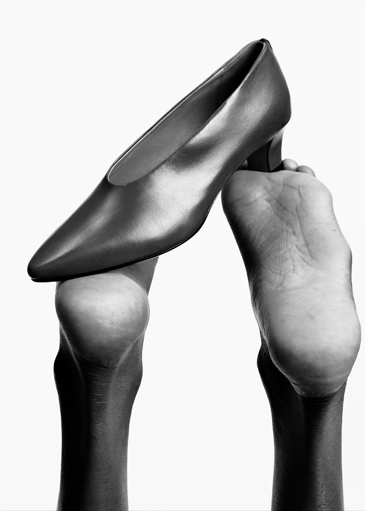 Model posing with a shoe on her feet