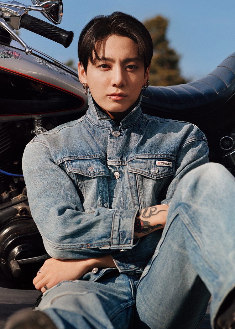 Jung Kook posing in a denim jacket