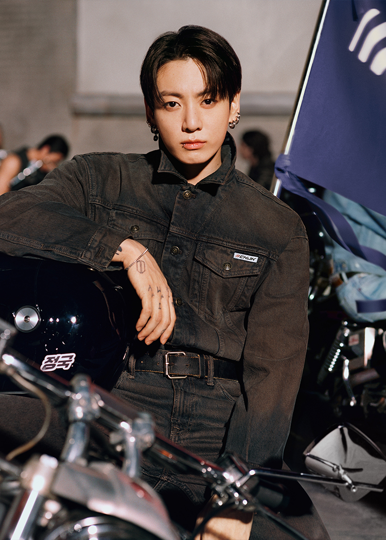 Jung Kook posing in a black denim jacket
