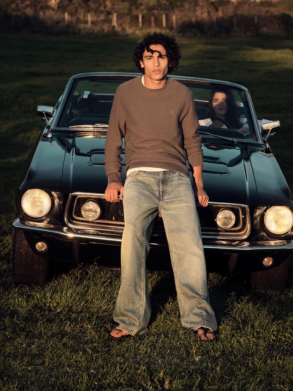 Model posing in light wash denim