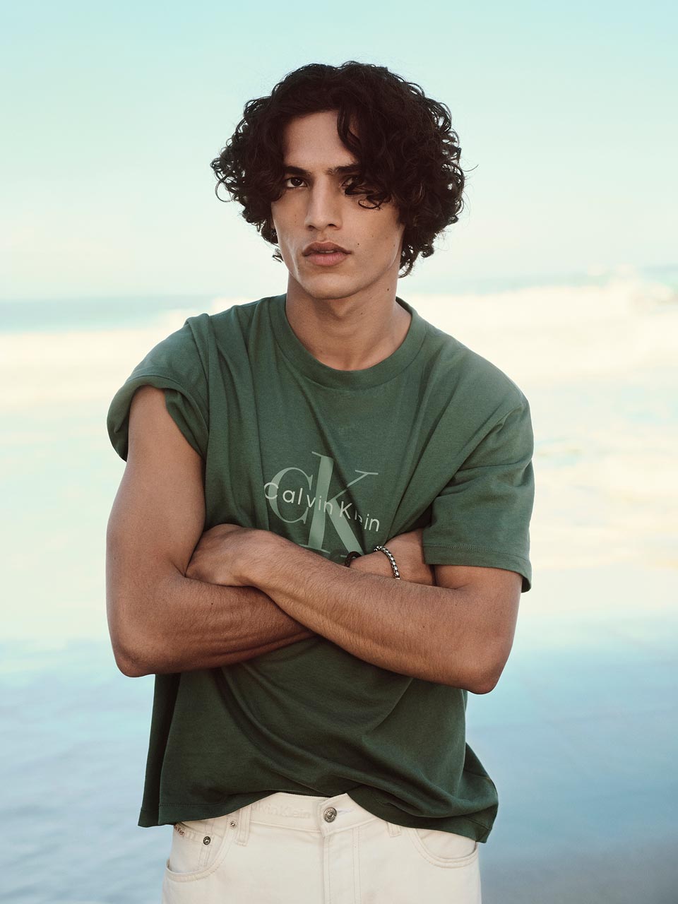 Model posing in a green CK logo t-shirt