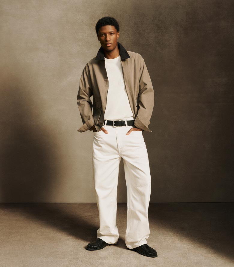 Model posing in a tan canvas jacket