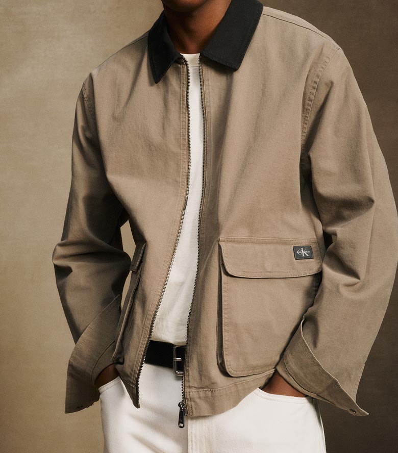 Model posing in a tan canvas jacket
