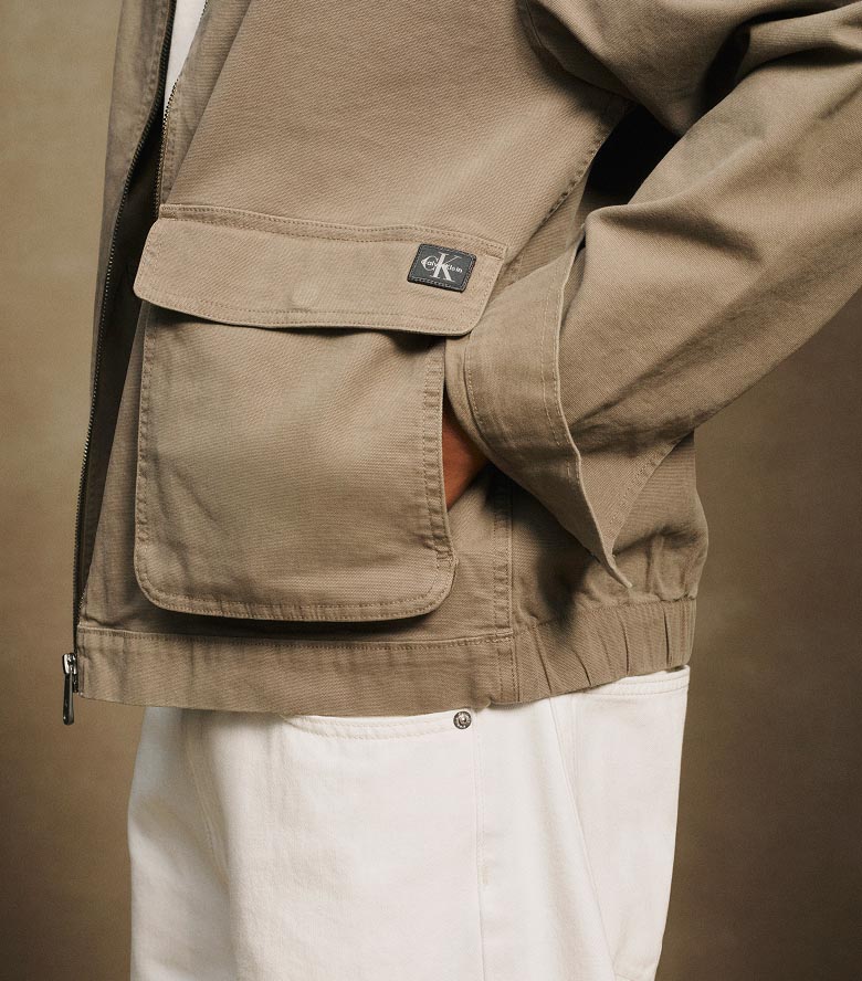 Model posing in a tan canvas jacket