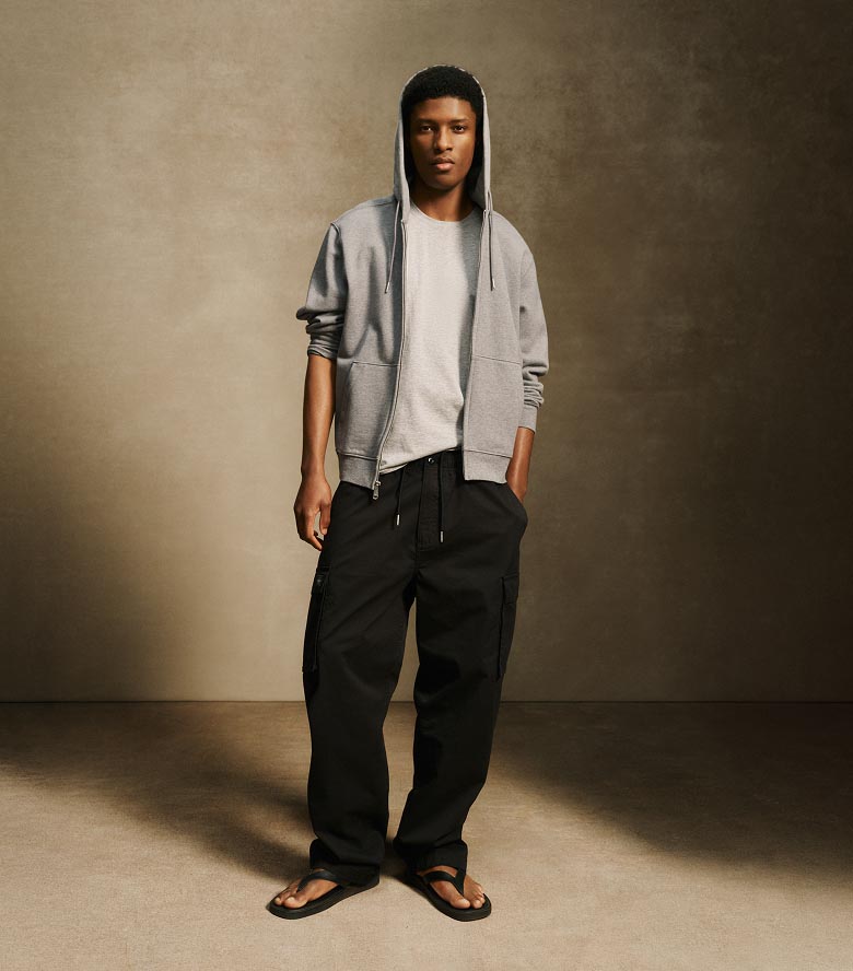 Model posing in black cargo pants