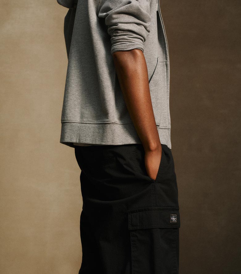 Model posing in black cargo pants