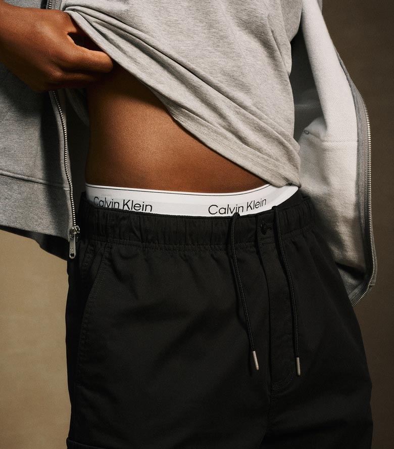 Model posing in black cargo pants