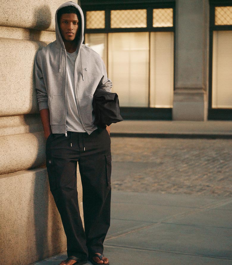 Model posing in black cargo pants