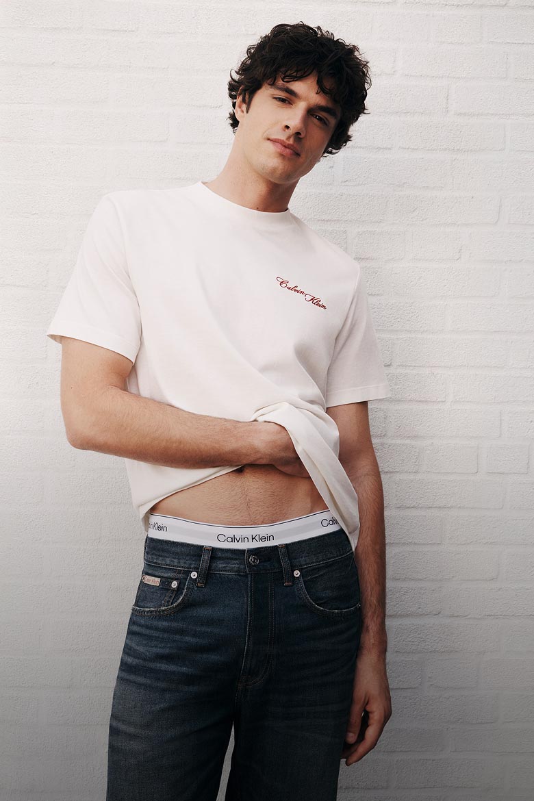 Model posing in a white logo t-shirt