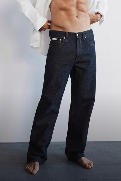 Model posing in dark wash 90s straight jeans