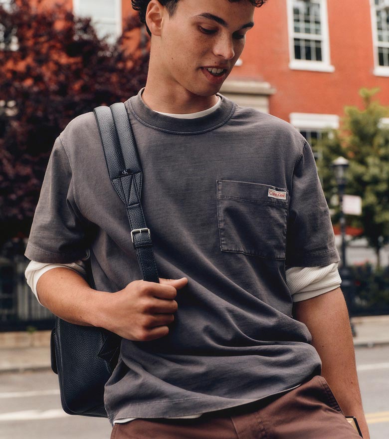Juan Lucas posing in a grey t-shirt and chinos