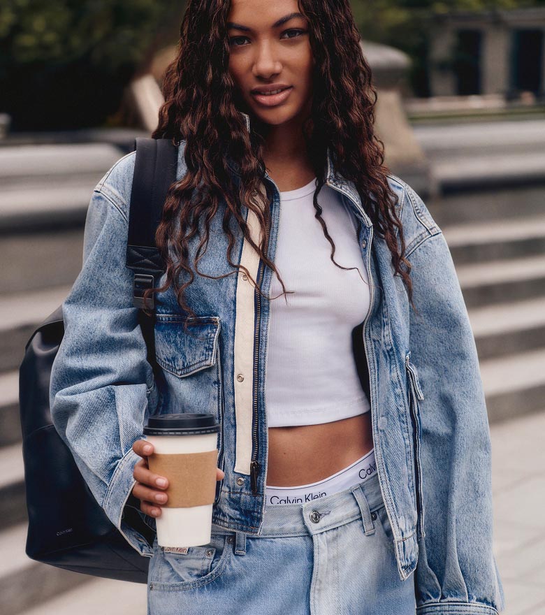 Via posing in a denim cropped jacket, white t-shirt, and baggy jeans