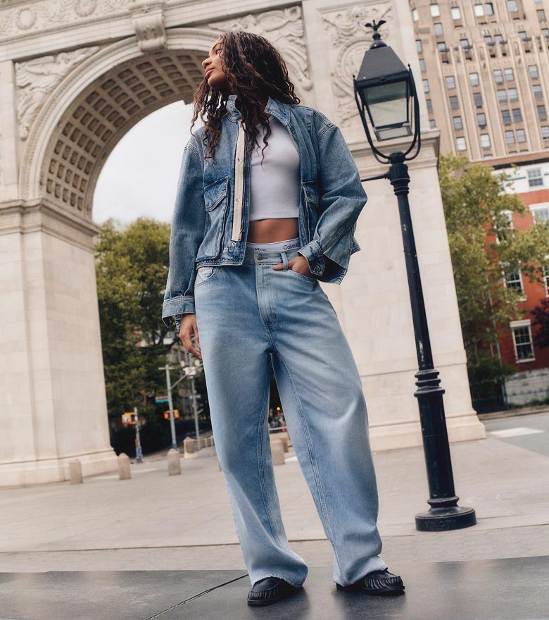 Via posing in a denim cropped jacket, white t-shirt, and baggy jeans