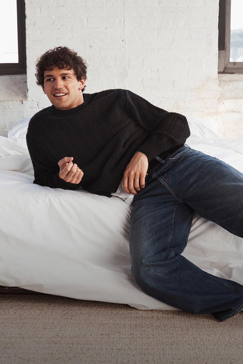 Model posing in a black sweater