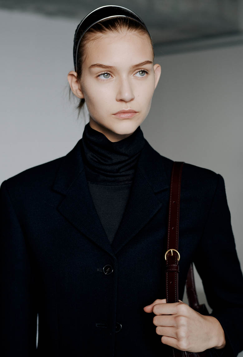 Model wearing a black tailored jacket backstage