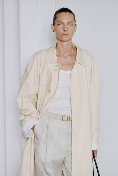 Model wearing a cream suit backstage