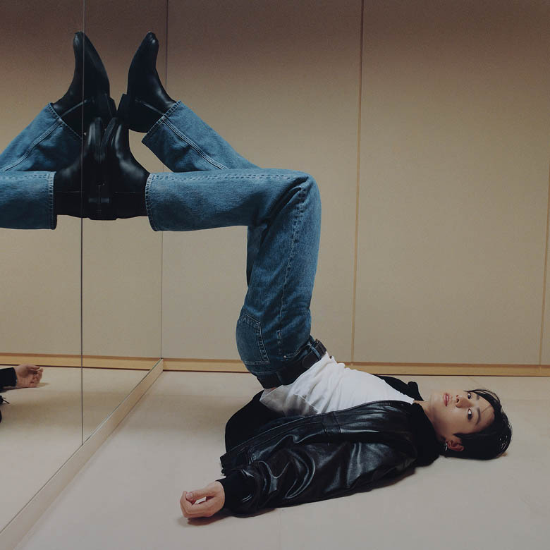 Jung Kook posing in a Leather Bomber Jacket and Straight Jeans