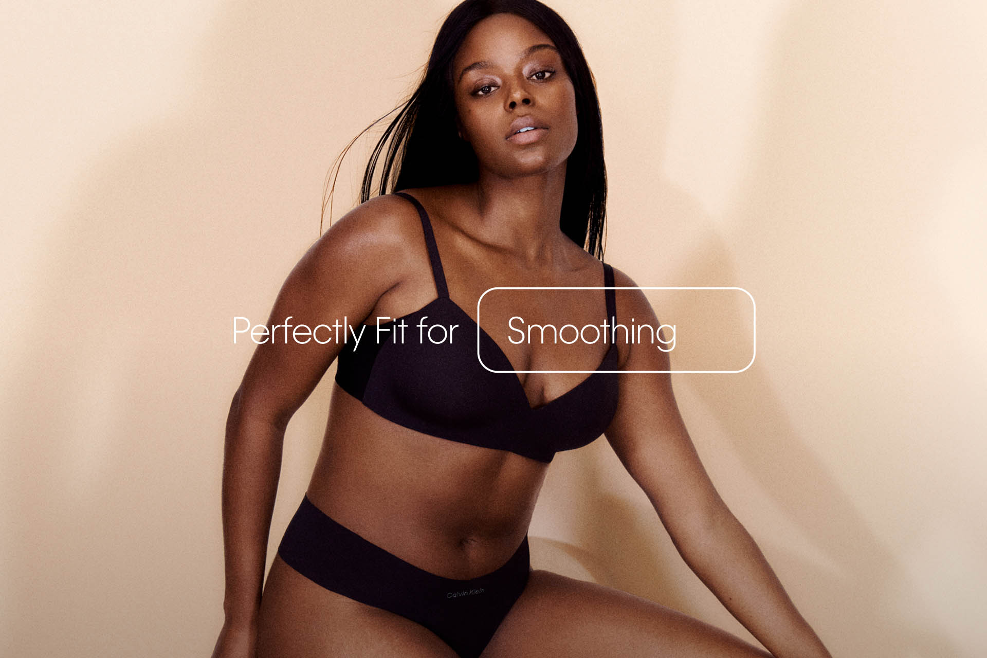 A model posing in a black Perfectly Fit Triangle bra