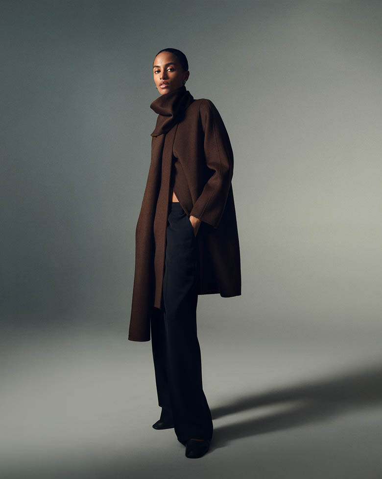 Model posing in a brown scarf coat
