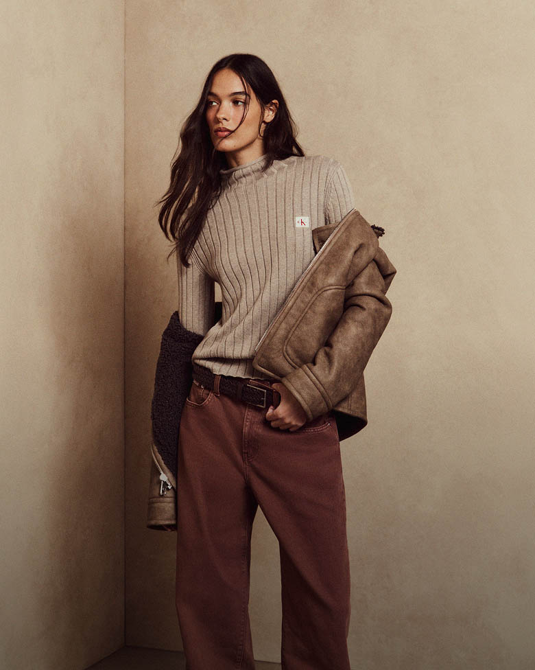 Model posing in a grey monologo turtleneck sweater