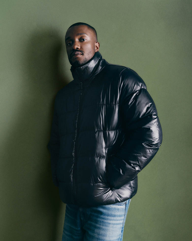 Sebastian Jean in a short black puffer jacket