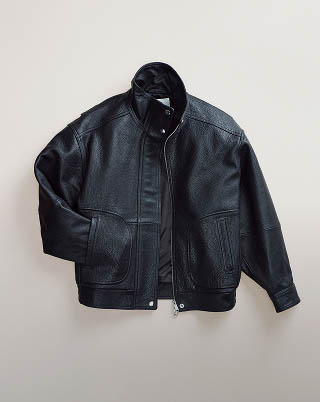 Still life image of a black bomber jacket