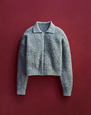 Still life image of a grey boucle sweater