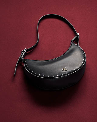 Still life image of a black studded shoulder bag