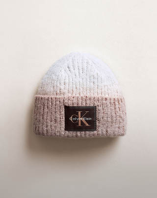Still life image of a pink and white beanie