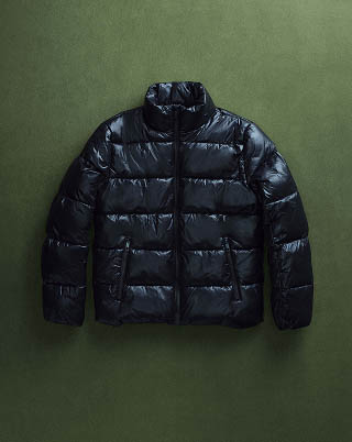 Still life image of a black puffer jacket