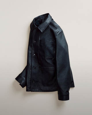 Still life image of a black leather chore jacket