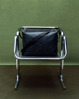 Still life image of a black messenger bag