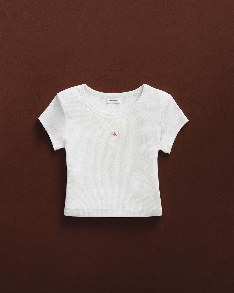 Still life image of a white t-shirt with a CK logo