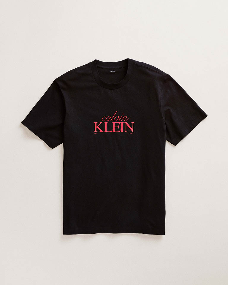 Still life image of a black t-shirt with a Calvin Klein logo